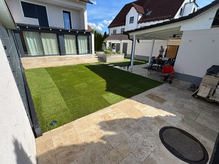 Modern hinterland garden with newly laid artificial grass and patio